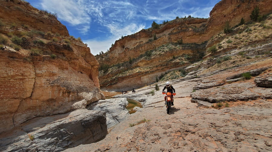 rider clibing out of a  canyon 