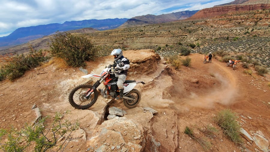 rider at clearing the edge at the of a steep climb