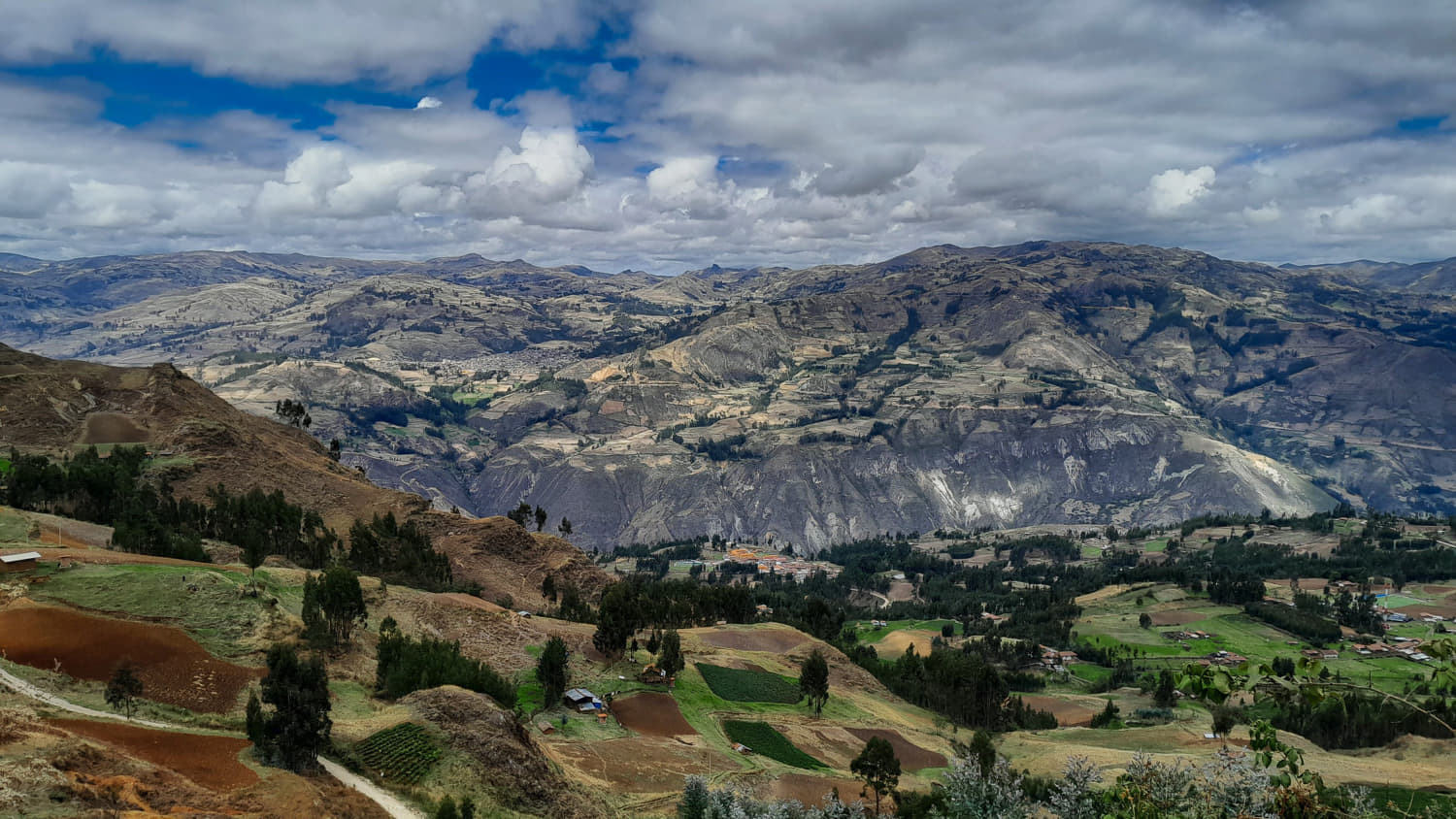 view of farms scattered over mountains