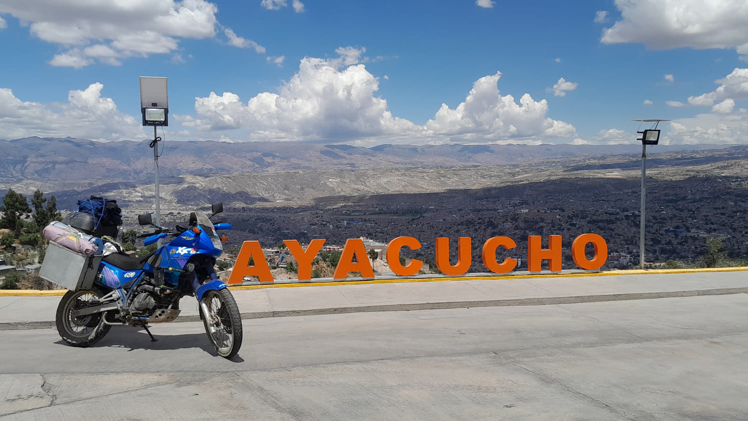 motorcycle parked with sign Ayacucho behind