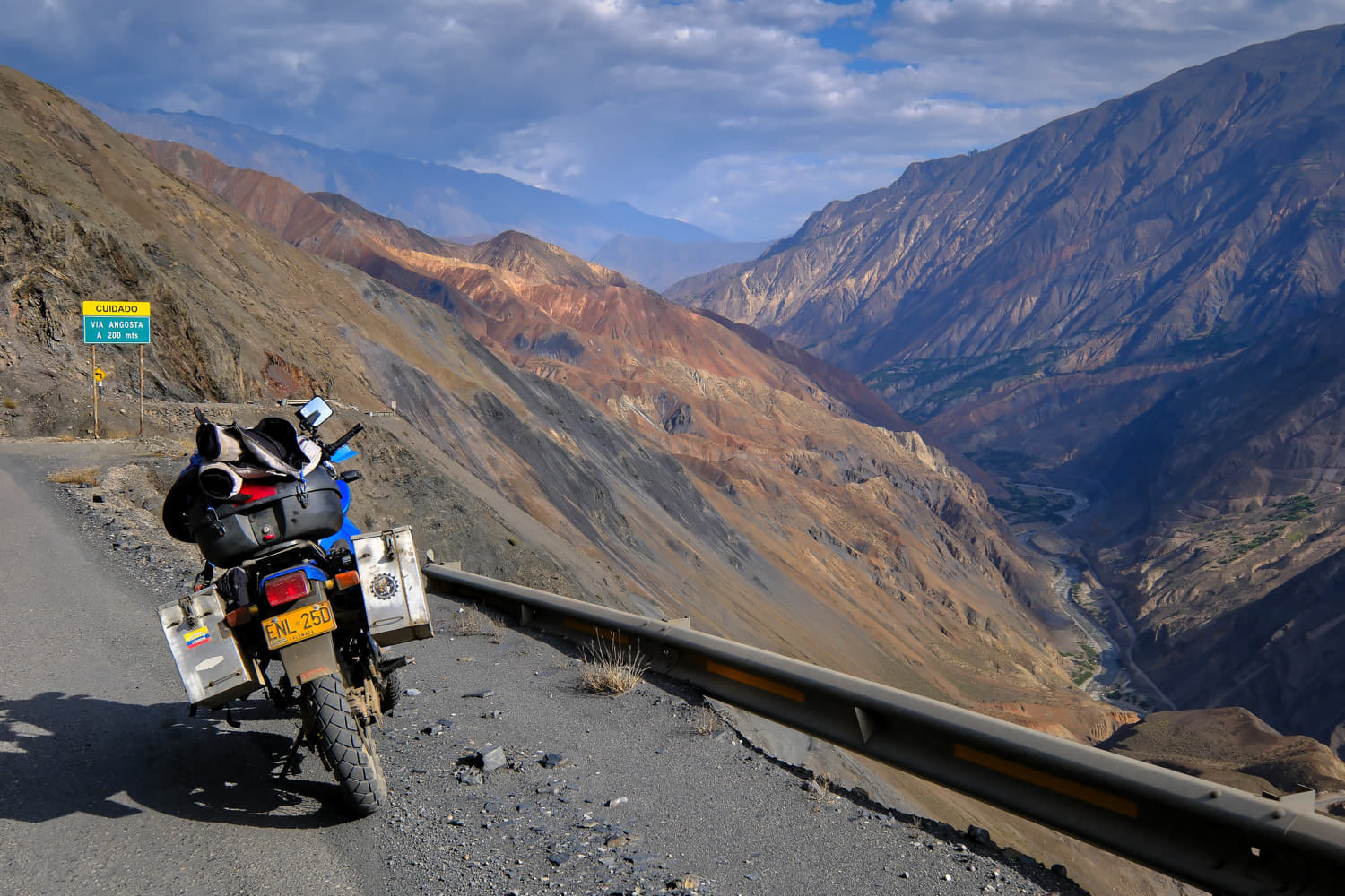 motorcycle parked on a road with colorful rocks around