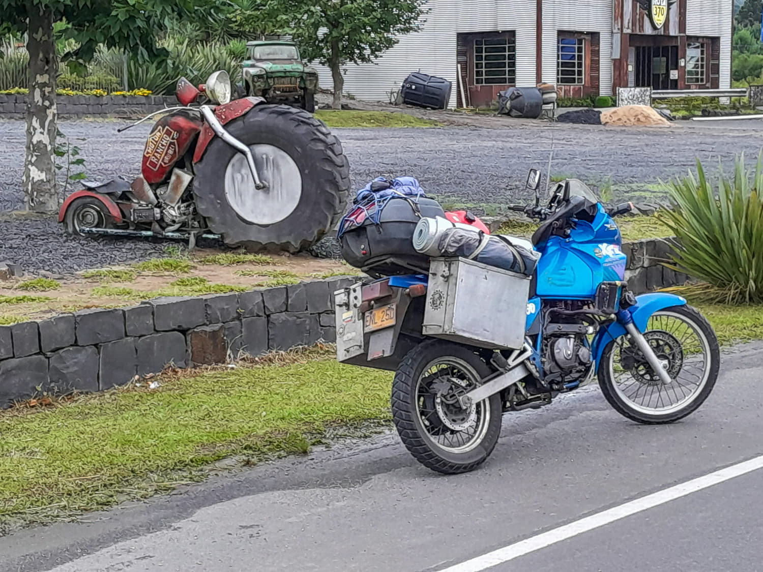 motorcycle parked next to a motorcycle sculpture