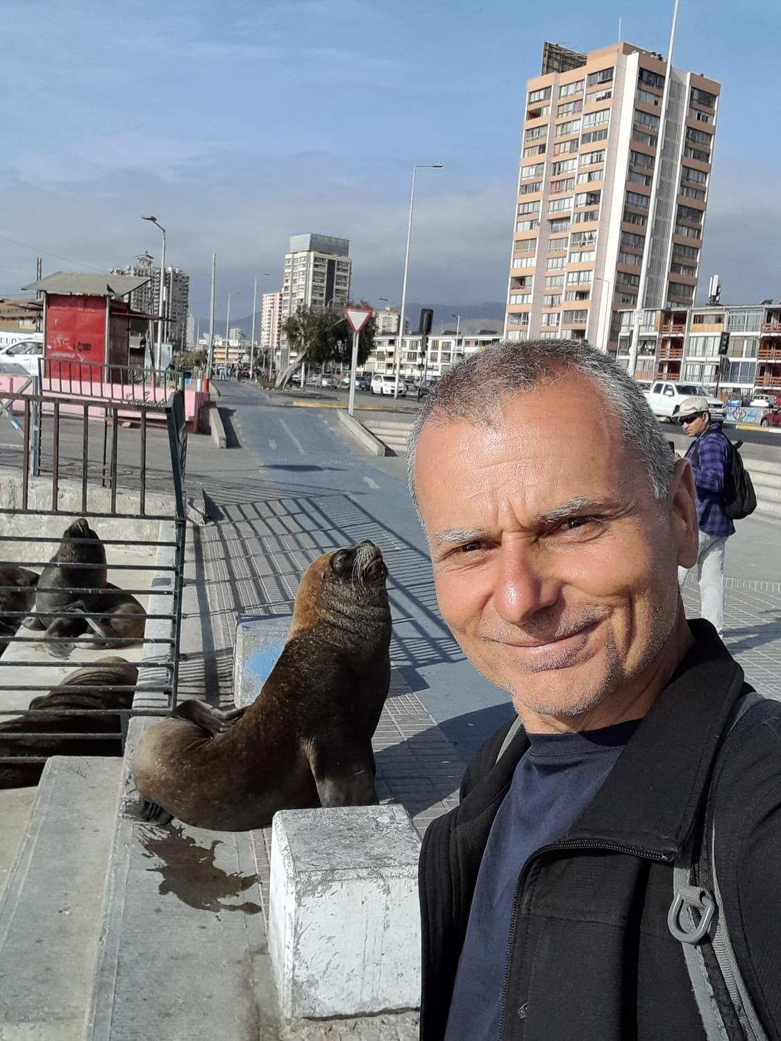 selfie in front of a sea lion on sidewalk