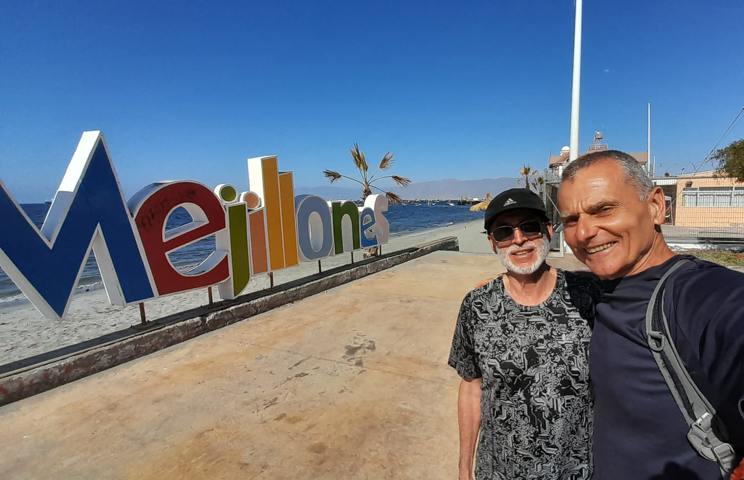 selfie with a friend next to Mejillones sign