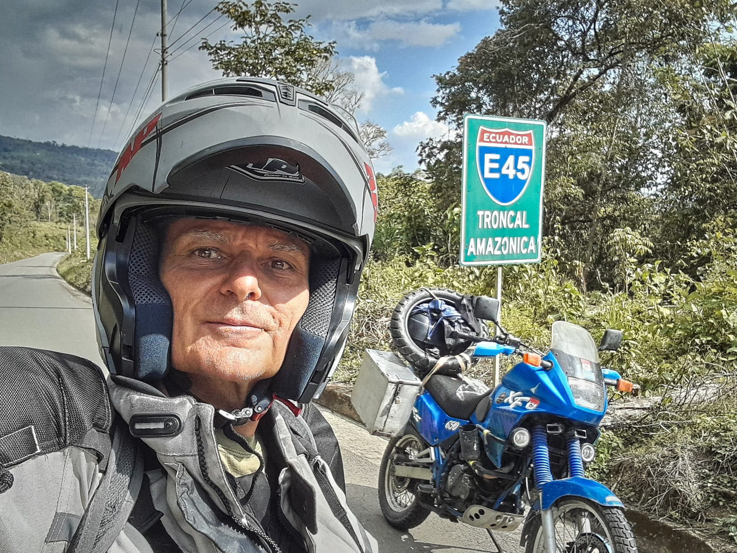 selfie next to a sign Troncal Amazonica 