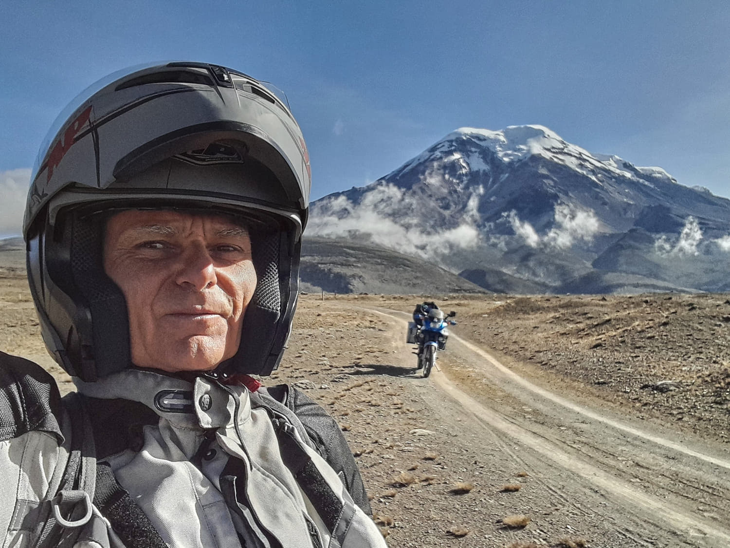 selfie with a snow covered peak behind