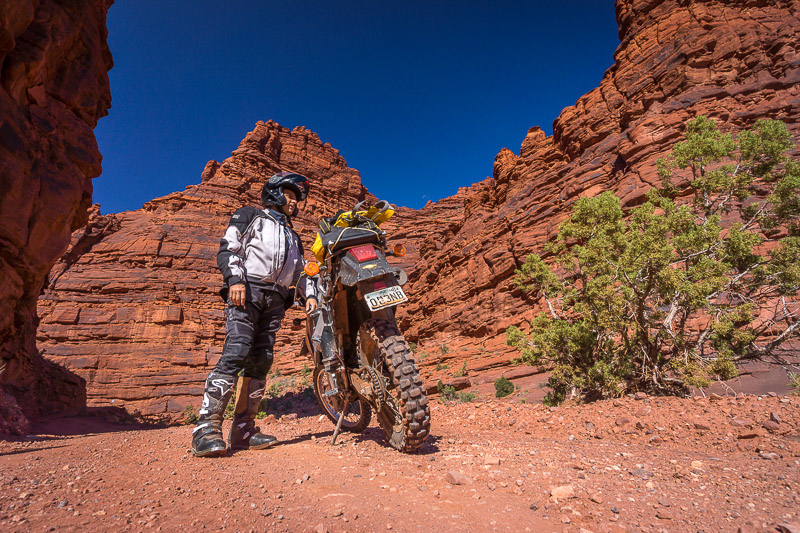 Posing with motorcycle in a narrow canyon