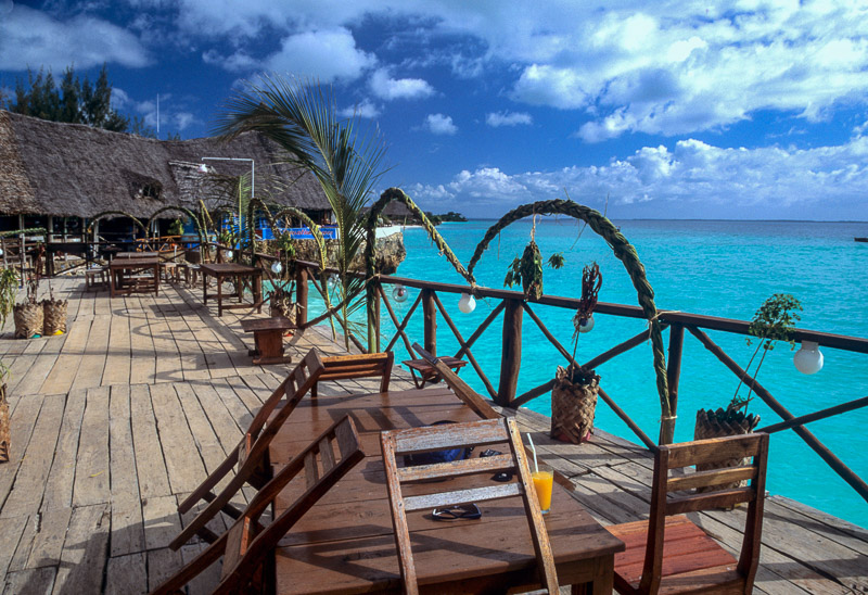 Restaurant with tables over the green-blue ocean