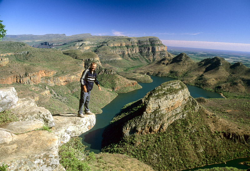 standing on the edge of an overhanging rock