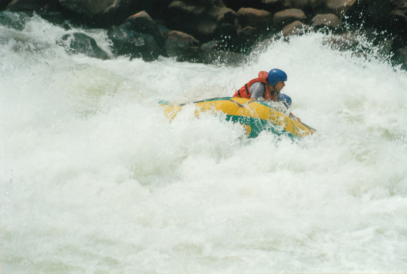 peaking from a raft engulfed by raging waves