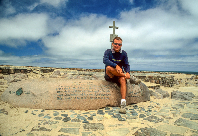 sitting next to a cross