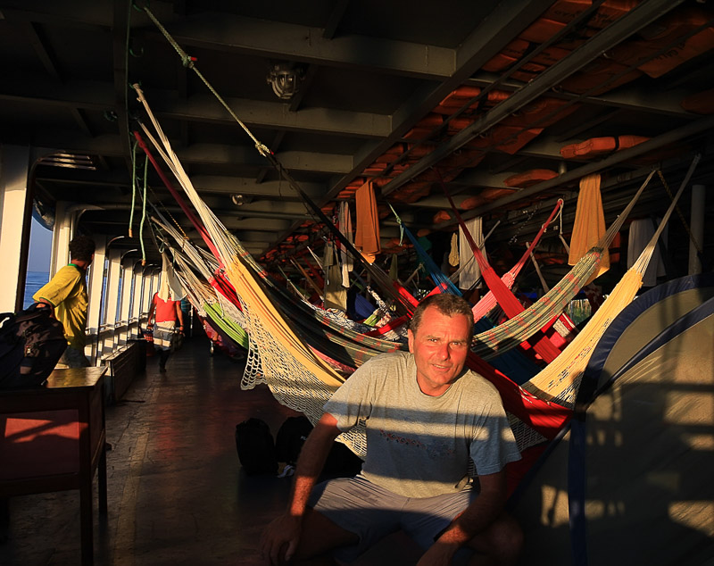 On an Amazon boat with hammocks strung behind