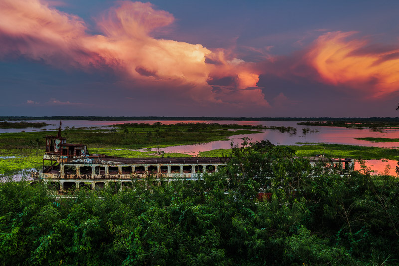 image of a beached boat and flooded plain behind 