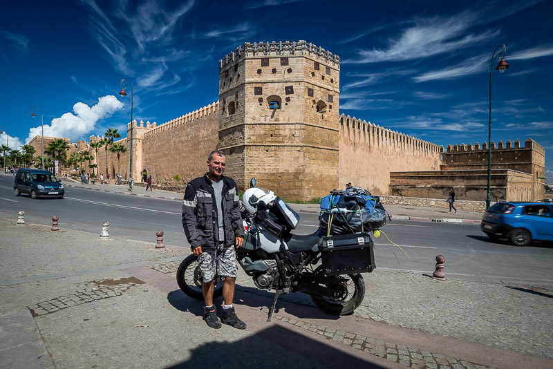 Posing with a motorcycle in front of city walls
