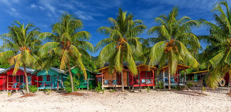 colorful huts with palm trees