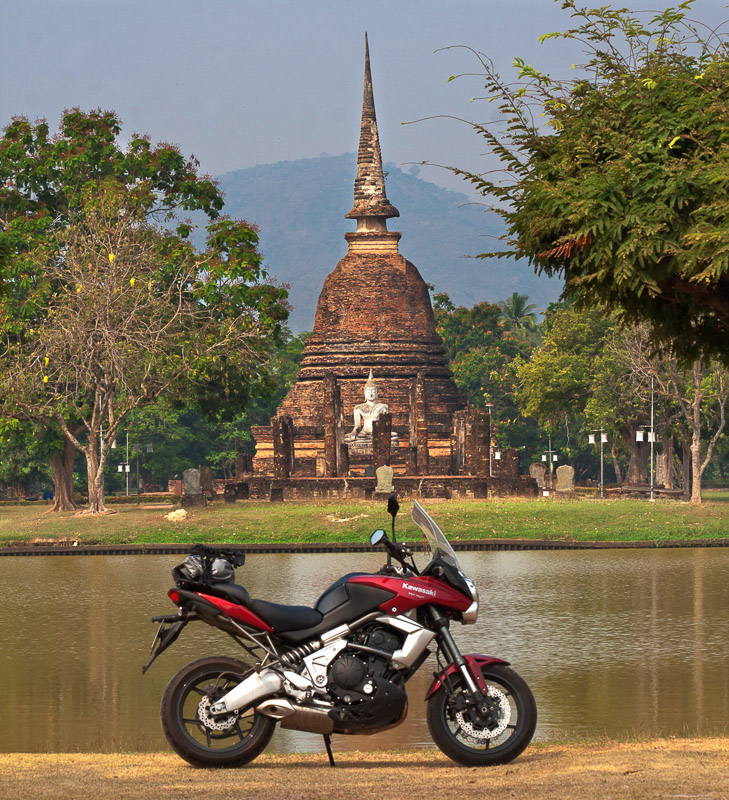 Motorcycle parked in front of a stupa