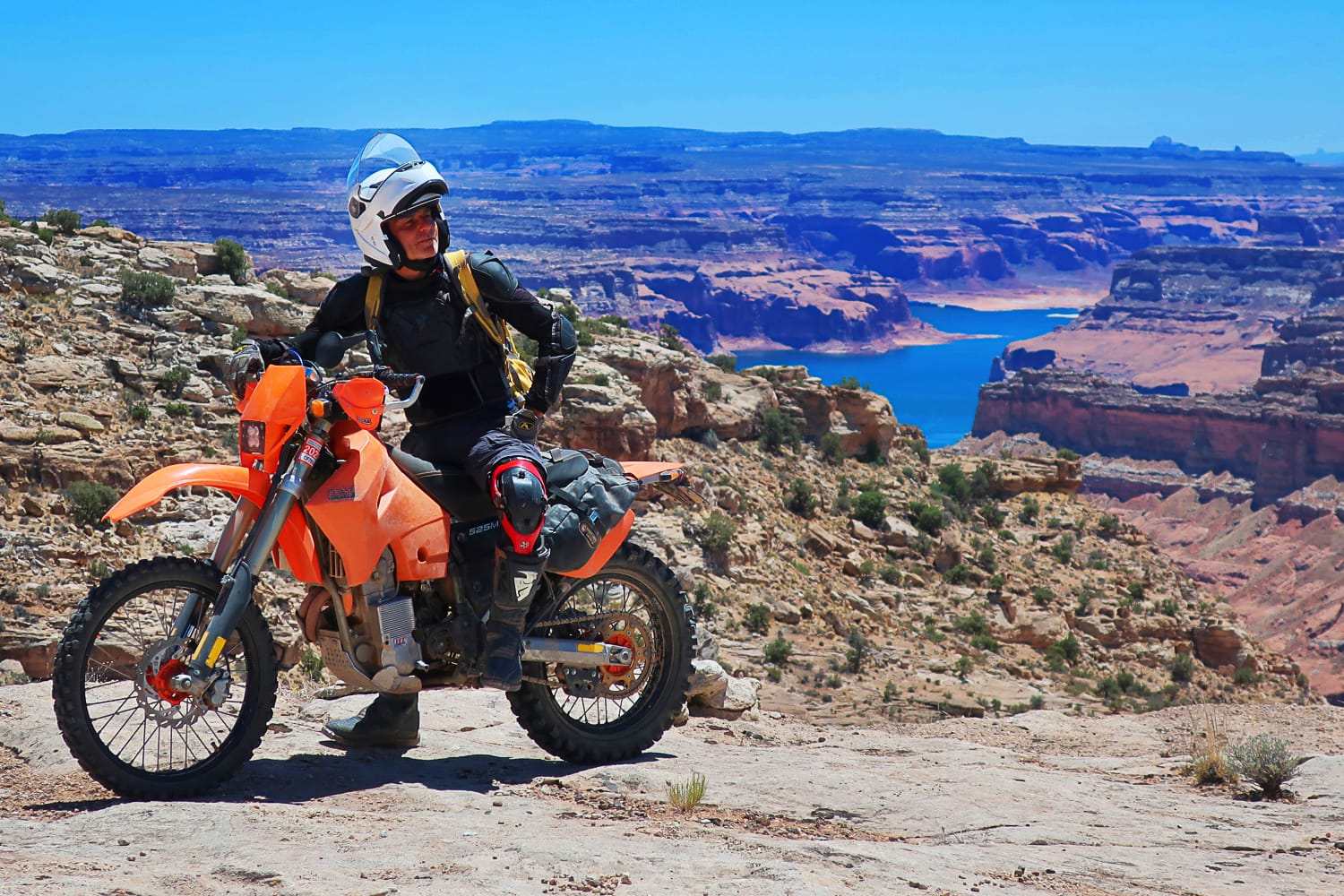 motorcycle rider high above lake powell