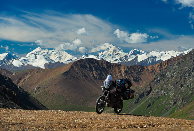 motorcycle with glacier-covered peaks in the distance
