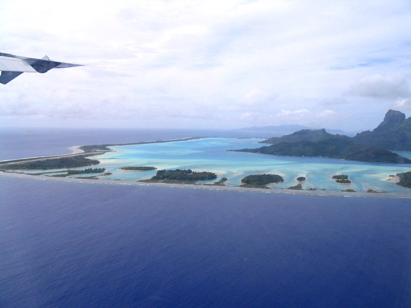 airplane circling a tropical island