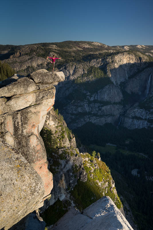 standing at the edge of a cliff in yosemite