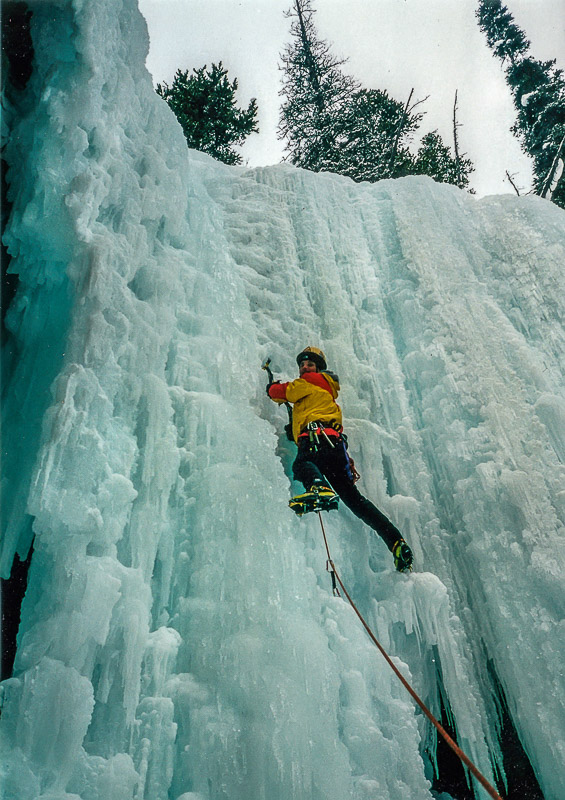 ice climber scaling a frozen waterfall