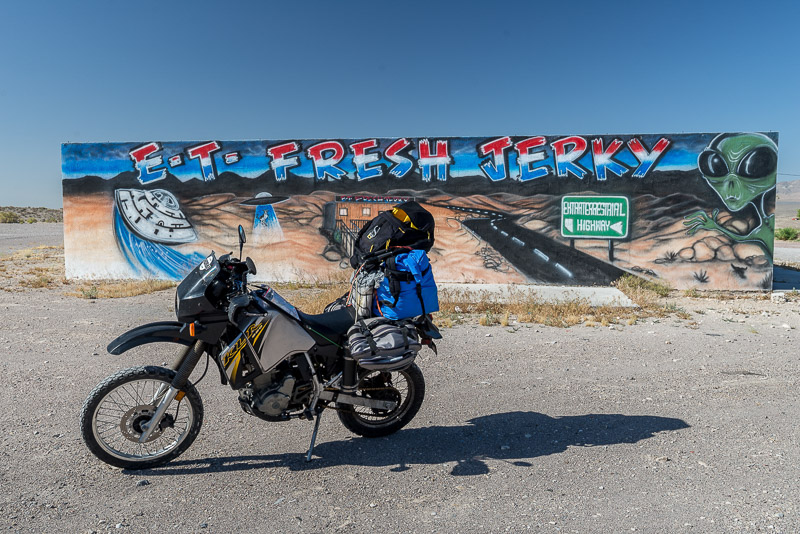 motorcycle parked in front of a big sign for ET jerky