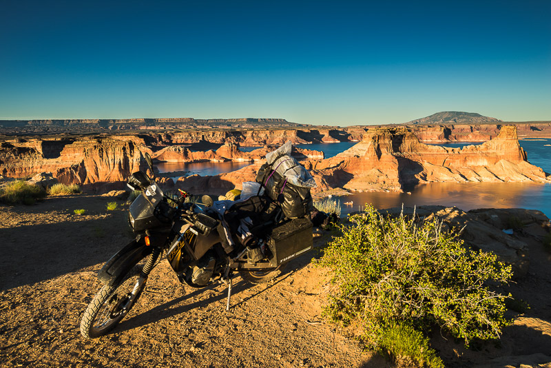 motorcycle parked at the edge of a mesa high above the lake
