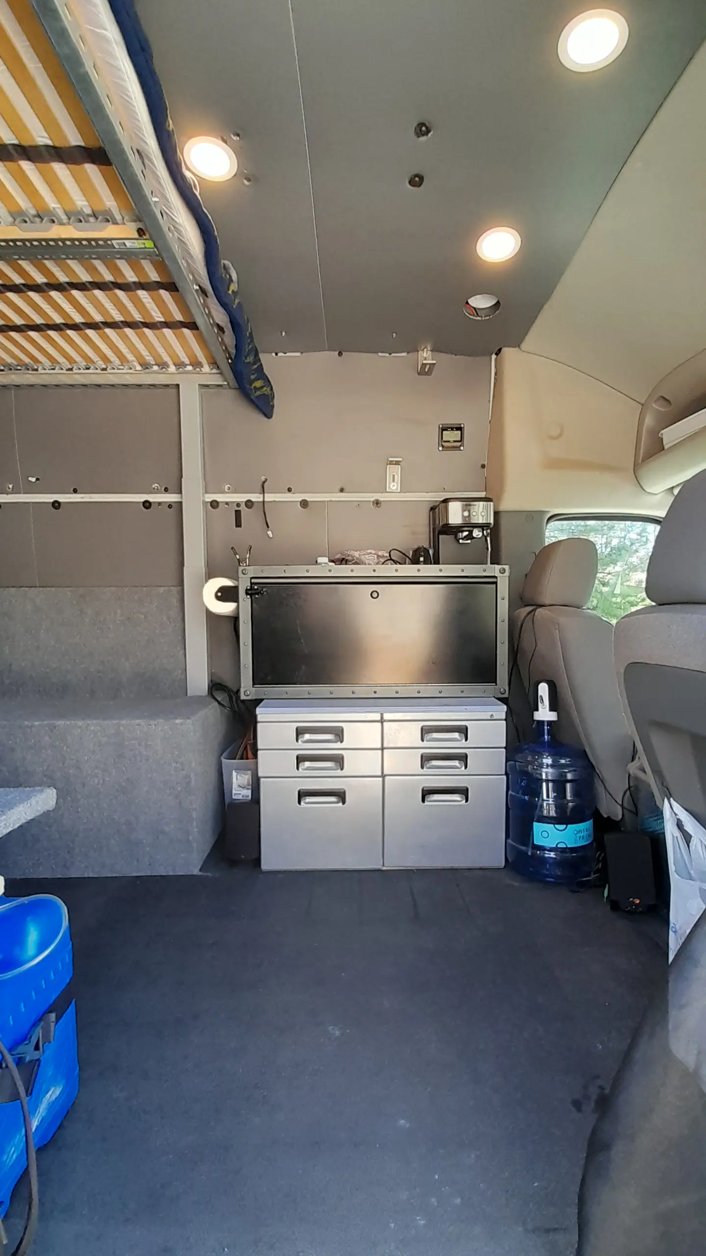 view of forward section of the van with working surfaces and espresso 
    machine