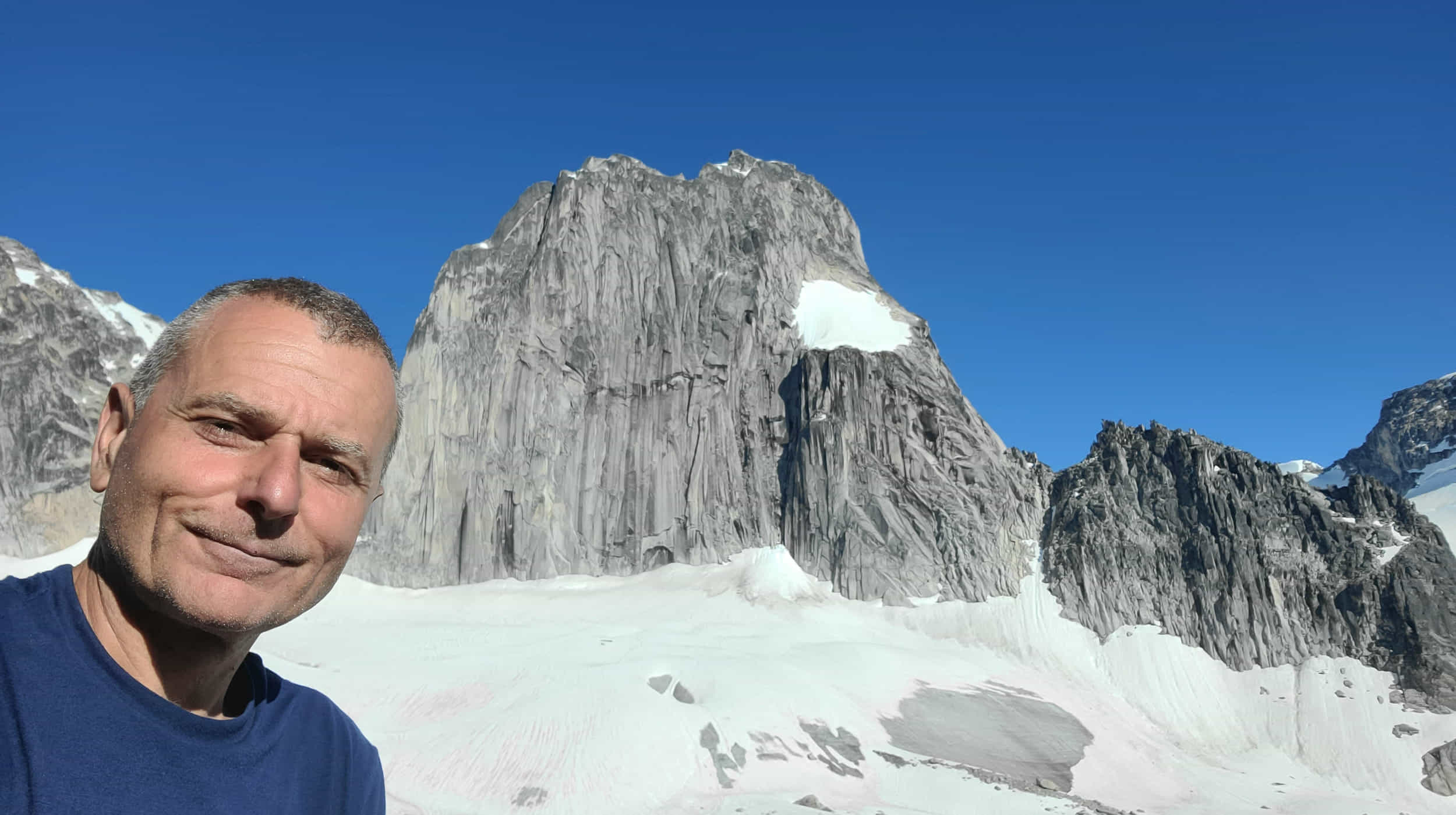 a selfie with rock monolith behind 