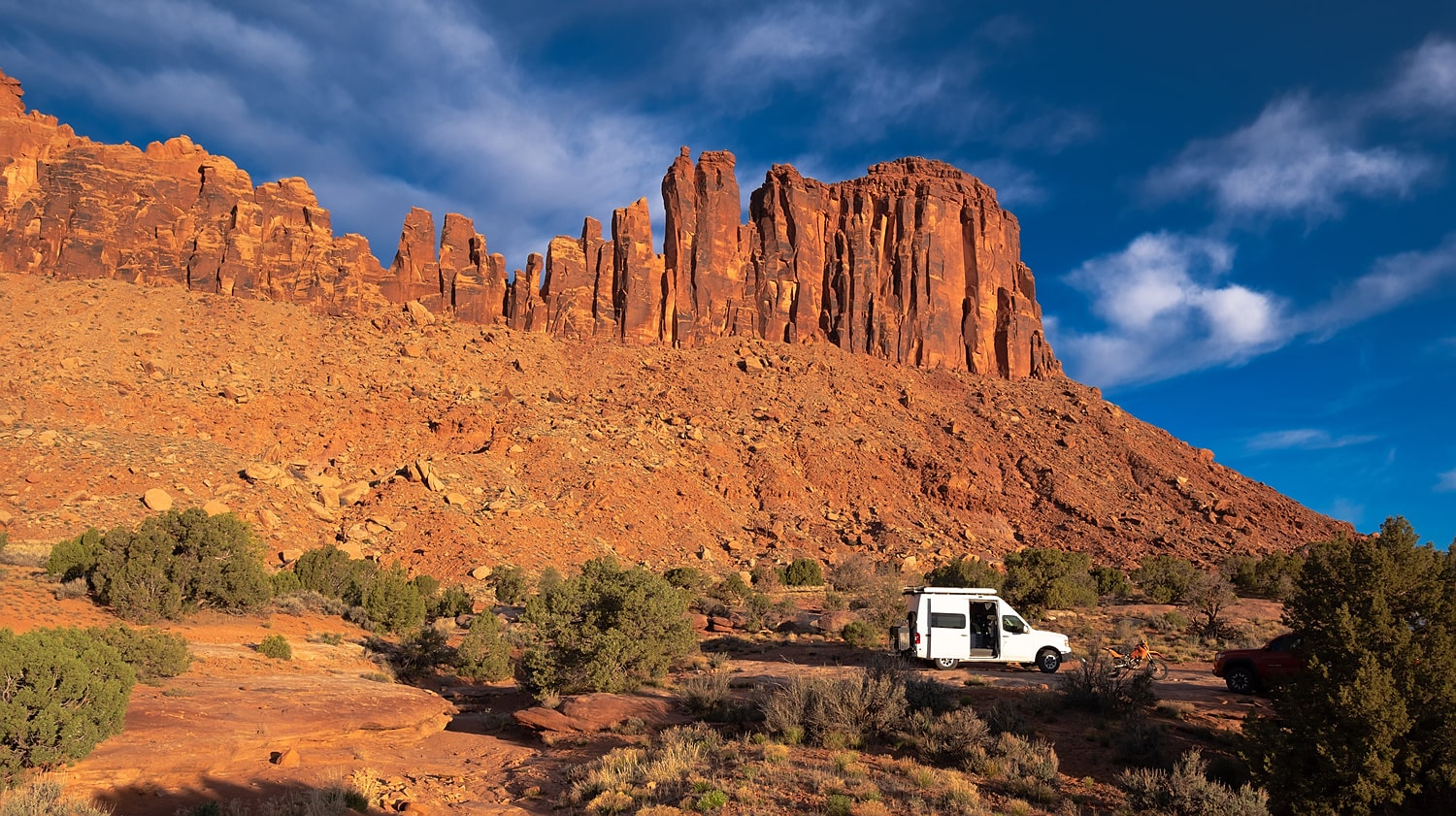 van and rock wall behind