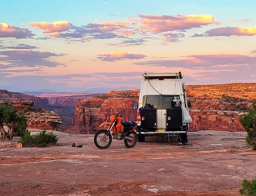 van and bike with a canyon behind