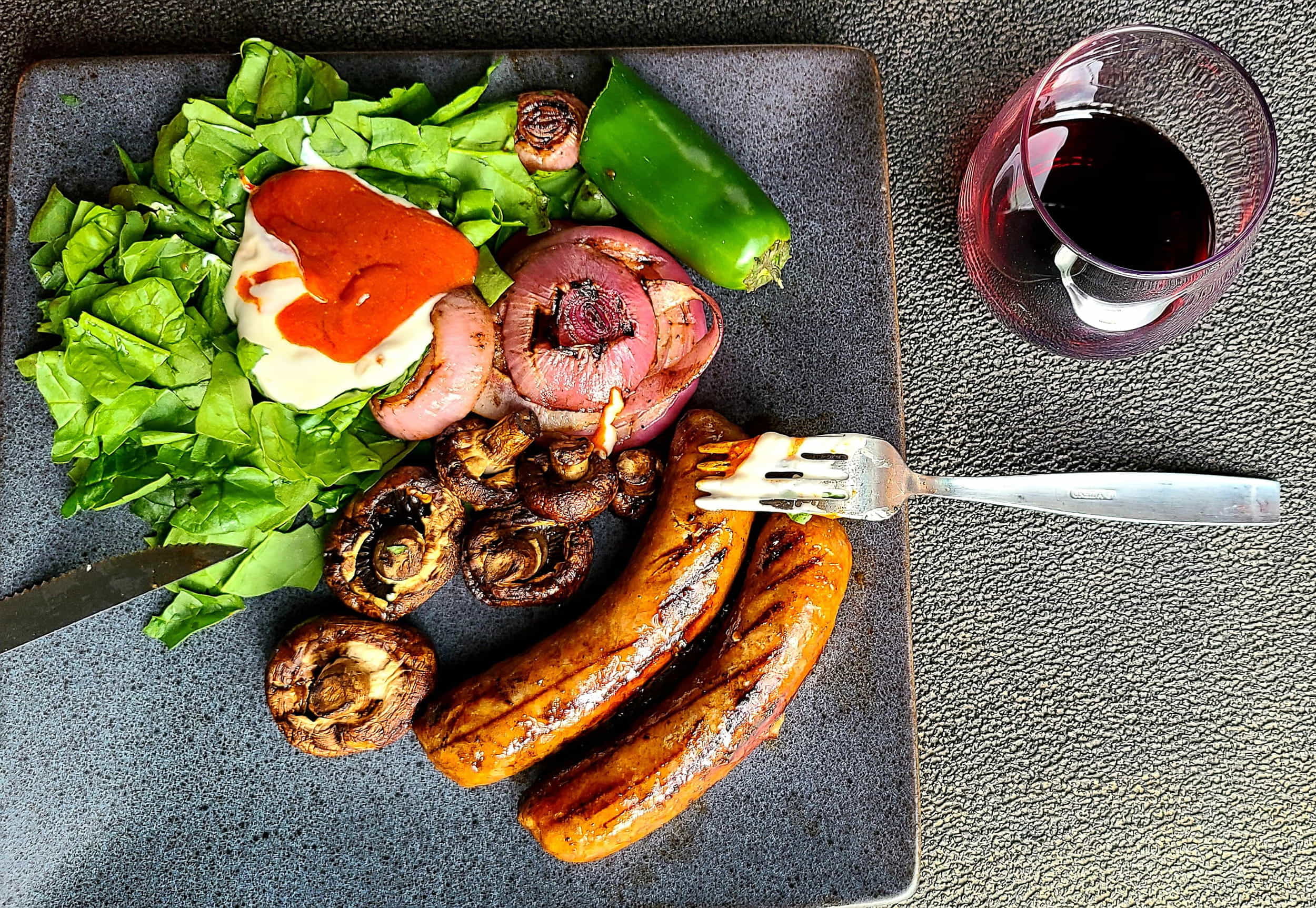 sausagges, salad and sauces on a plate