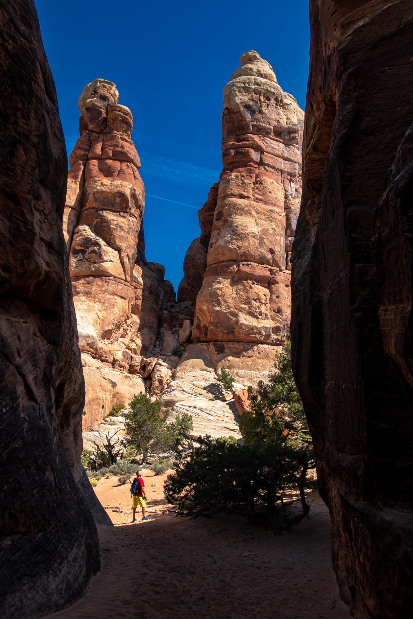 a person with rock spires behind 