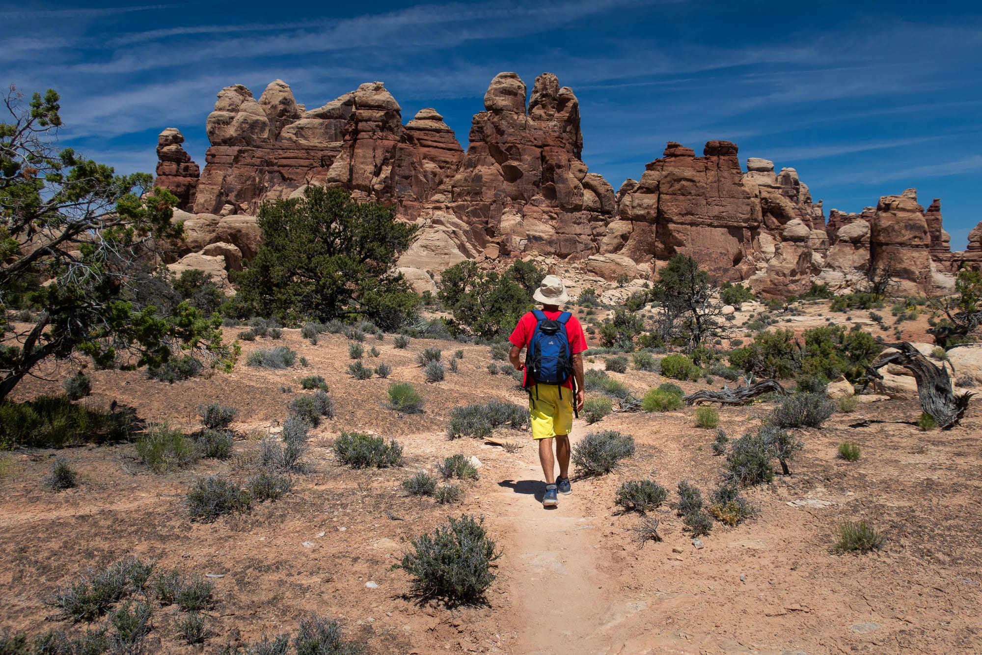 a person posing in front of rock spires 