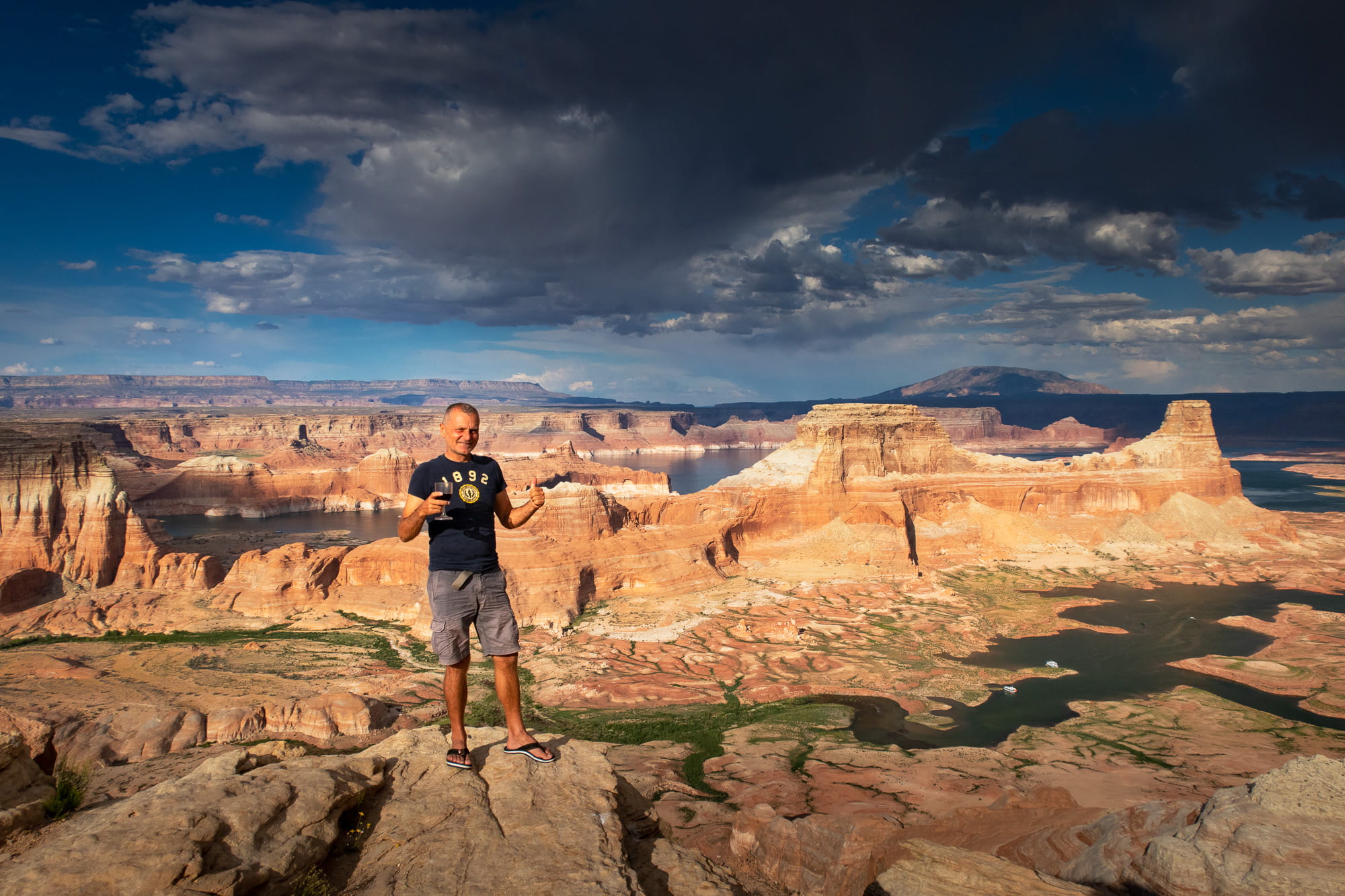 posing high above a lake and mesas in the distance 