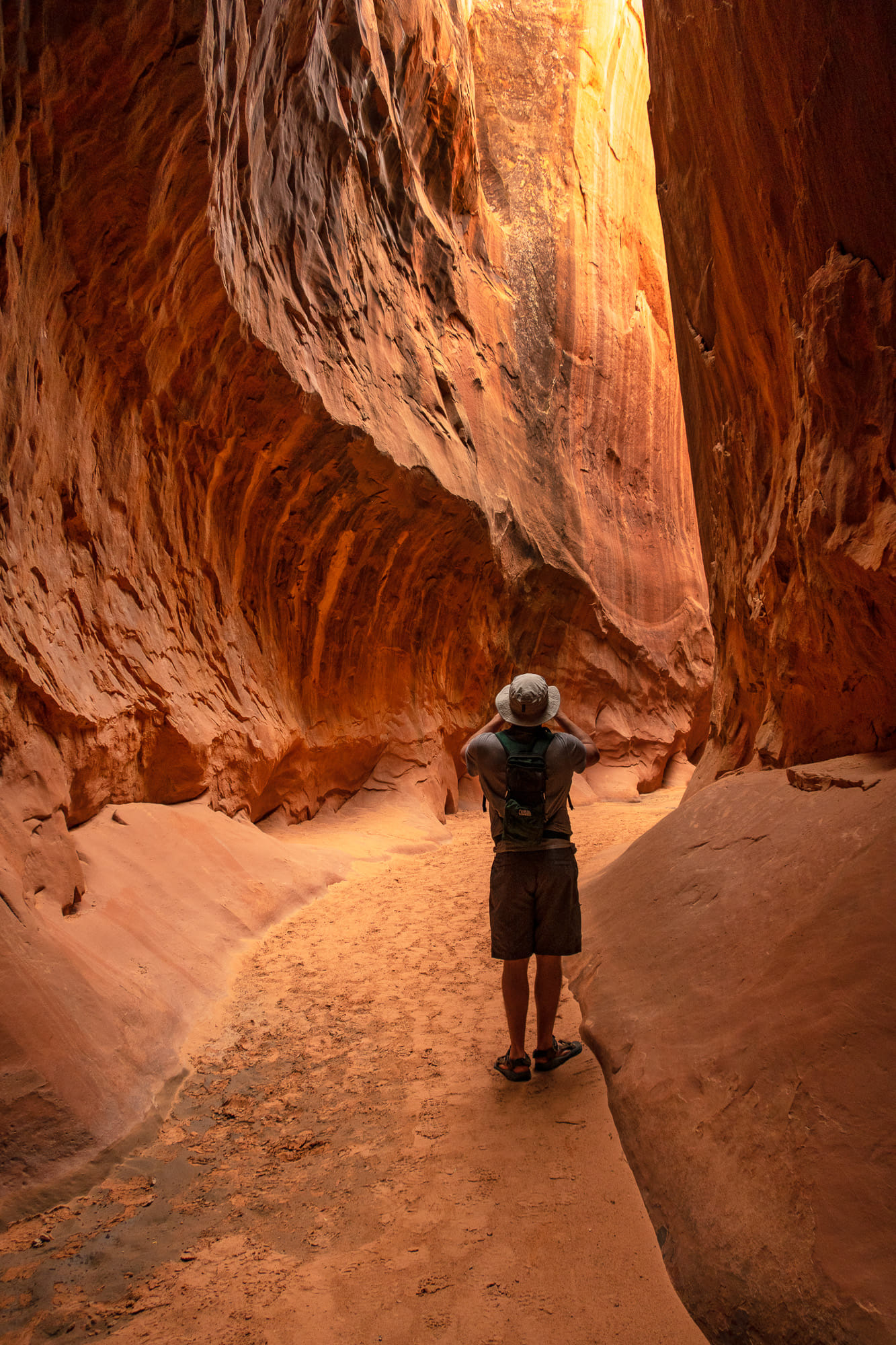 a person taking photos inside a canyon 