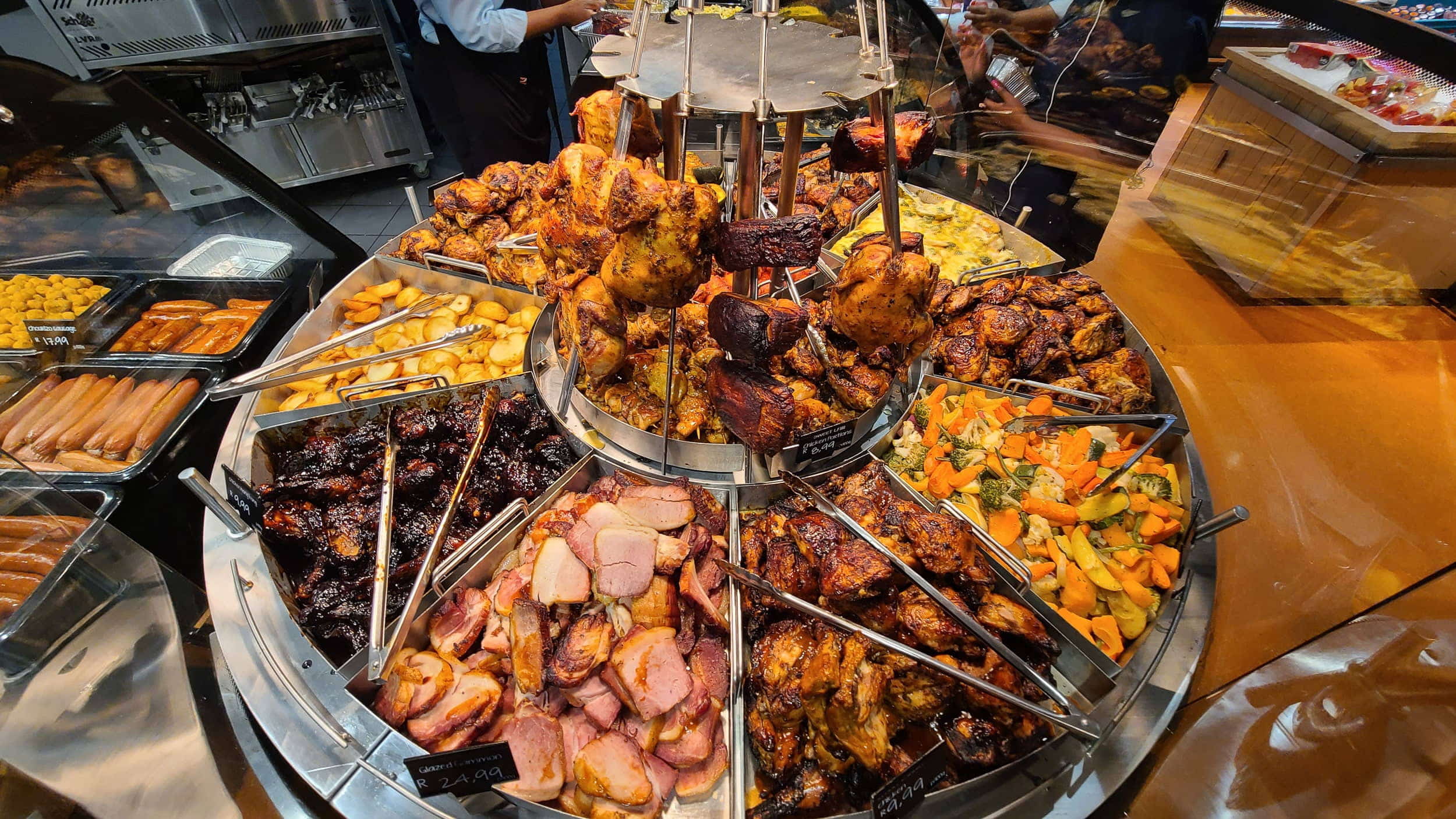 a round tray with various roasted veggetables and meats