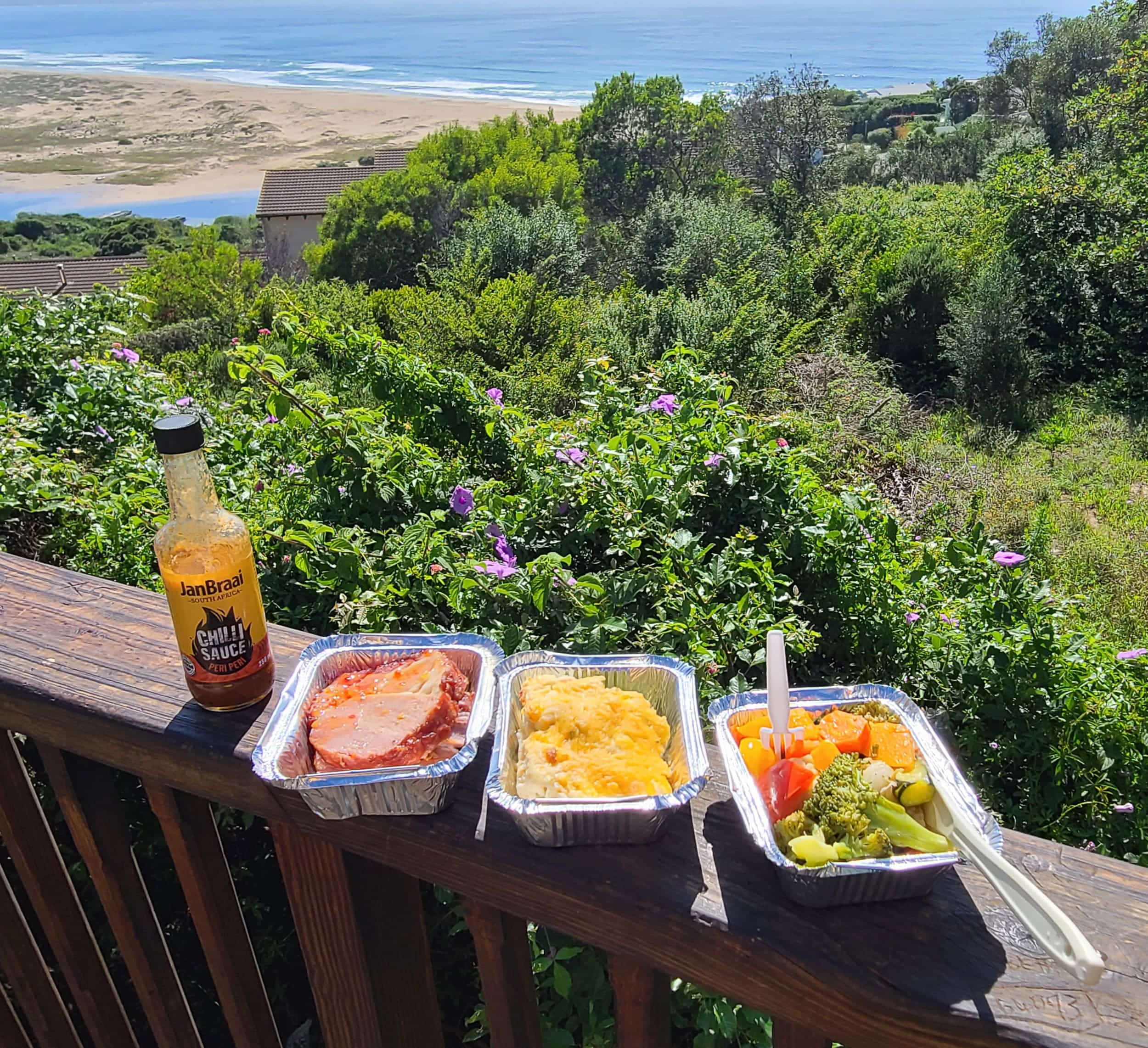 three boxes of food and beach behind