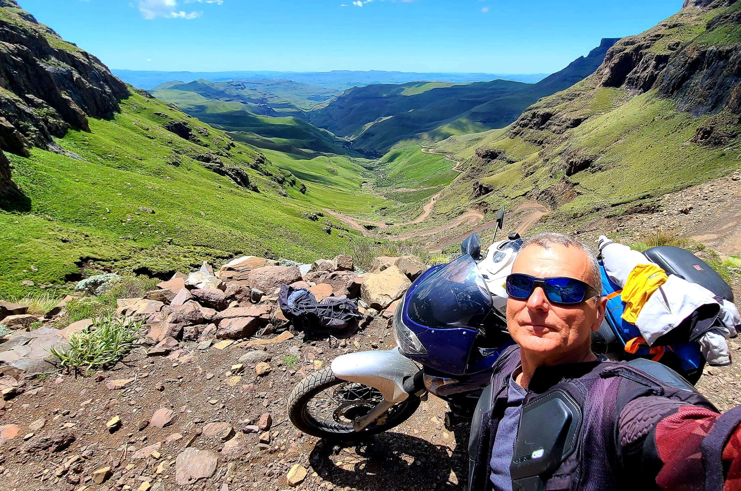 selfie with a motorcycle and switchbacks behind