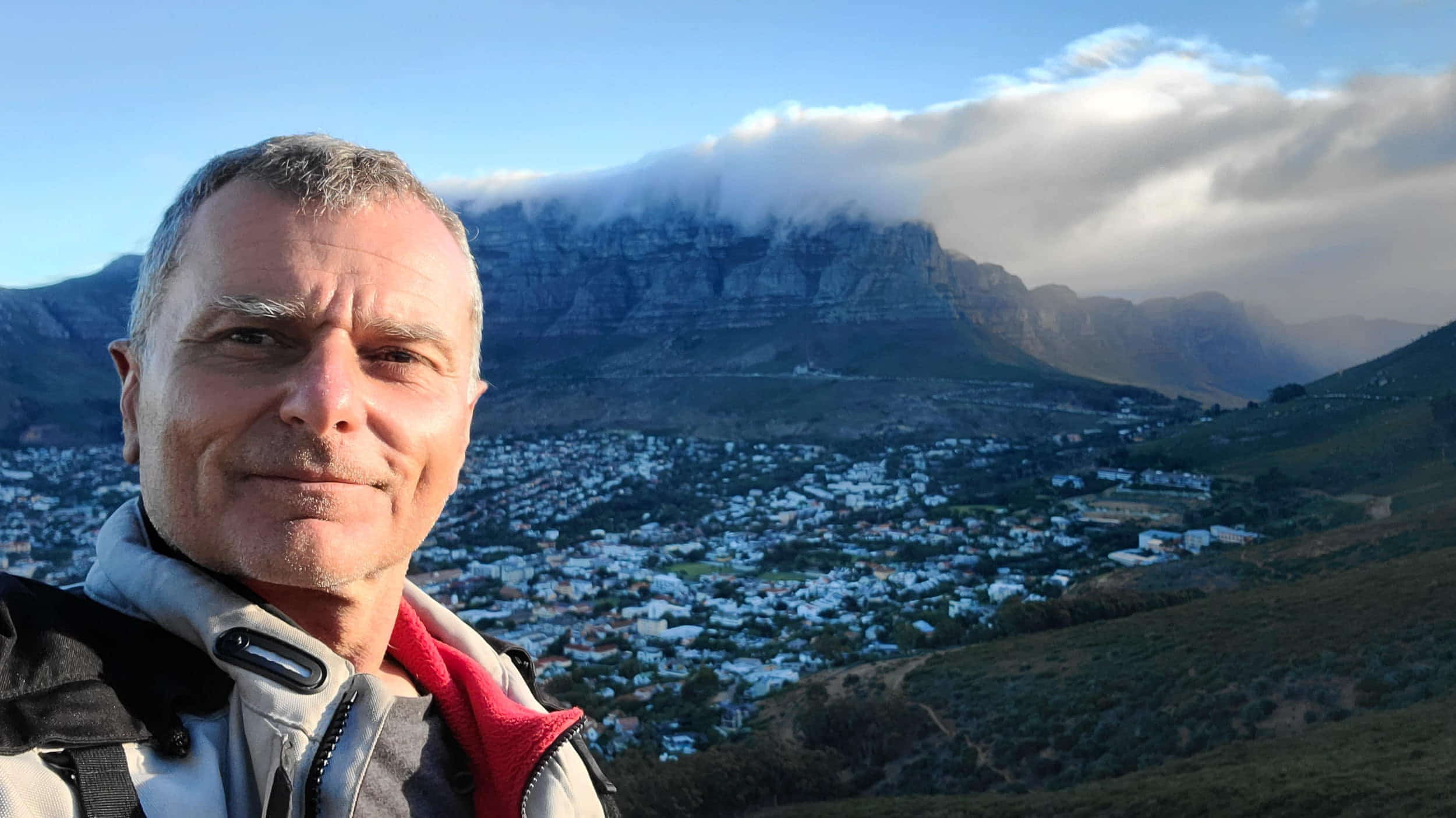selfie with cloud-covered table top mountain behind