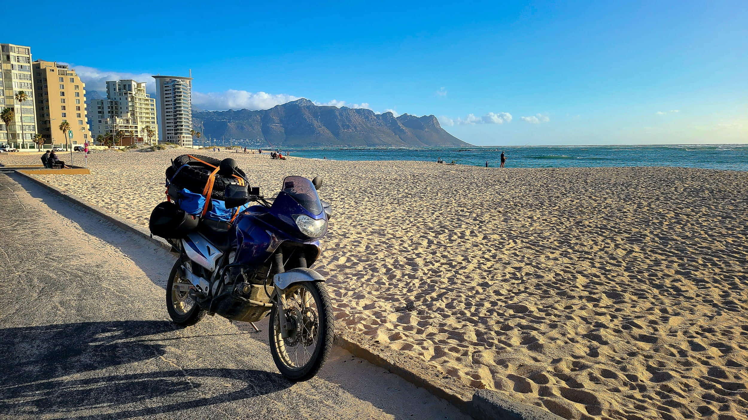 motorcycle parked in front of a beach 